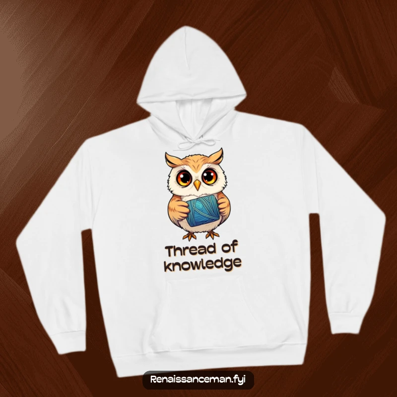 Funny hoodie showing a curious owl concentrating intently on a spool of bright thread, symbolizing dedicated craftsmanship.
